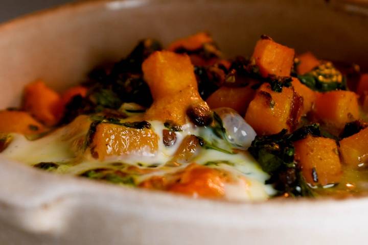 Butternut squash breakfast casserole cooking in a dish in the oven.