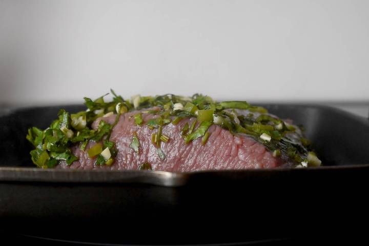 Flank steak being grilled for carne asada.