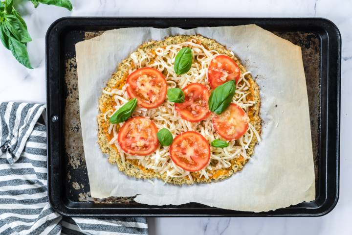 Cauliflower pizza  dough with tomatoes and cheese.