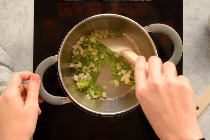 Jalapenos, garlic, and onions cooking in a pot.