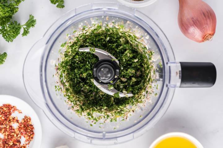 Ingredients for chimichurri in a food processor.