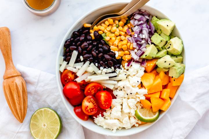 Chopped Mexican salad in a bowl with honey lime dressing.