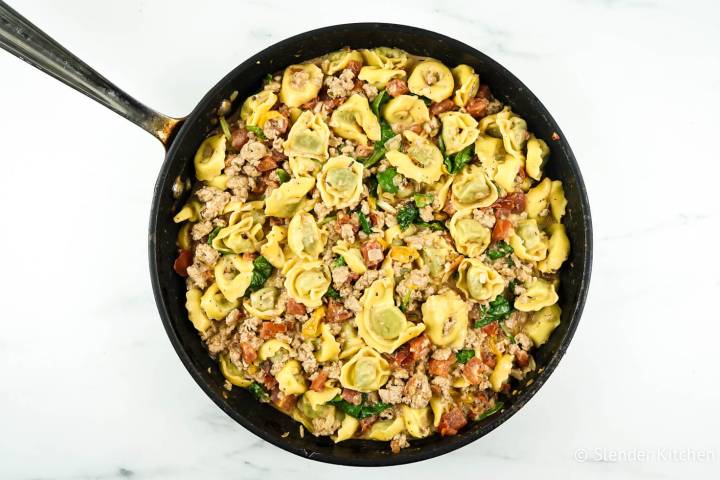 Creamy chicken tortellini with spinach in a cream cheese tomato sauce.