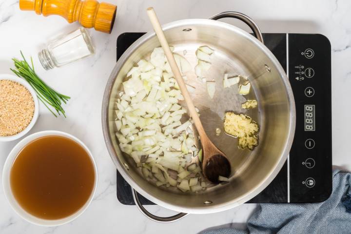 Onions and garlic cooking in a large pot.