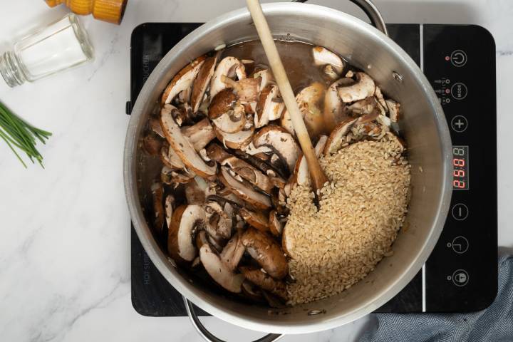 Brown rice and mushrooms in a large pot.