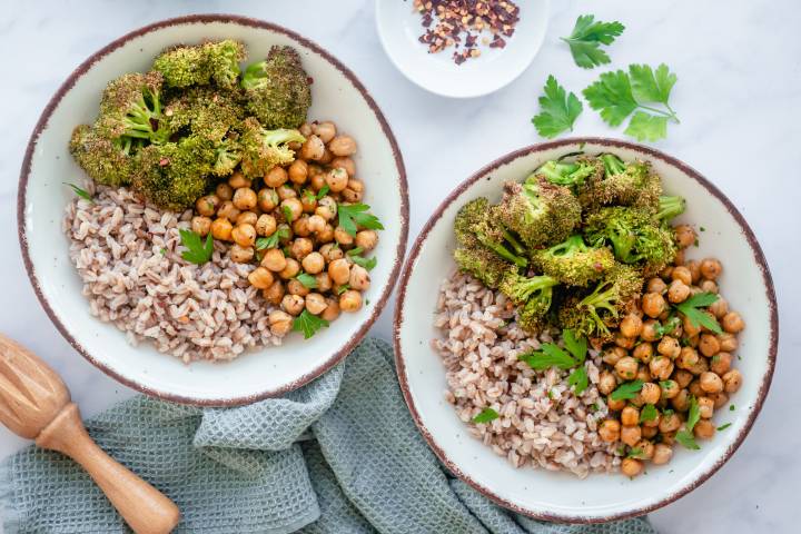 Farro and broccoli bowls with chickpeas served in two bowls.