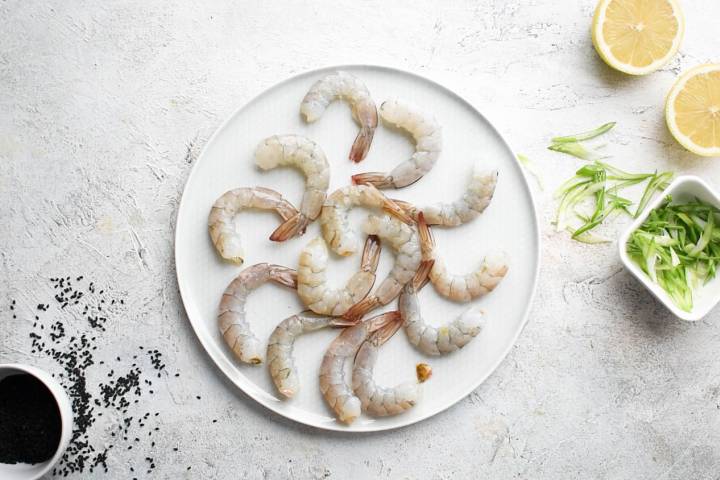 Peeled and deveined shrimp on a plate.