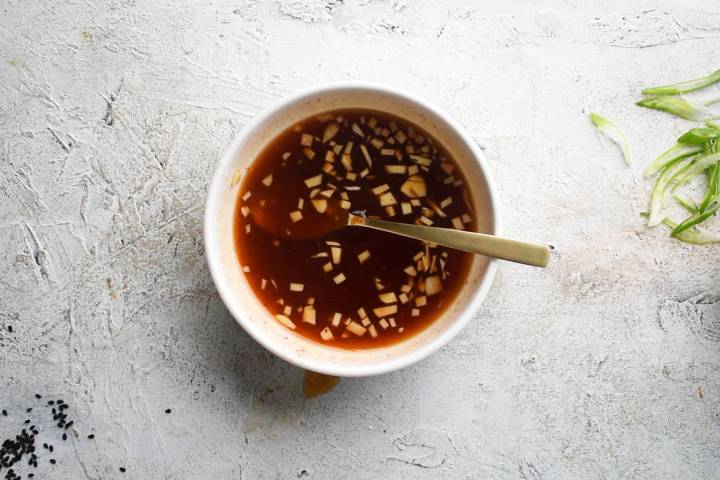 Firecracker sauce with garlic, soy sauce, honey, and Sriracha in a bowl.