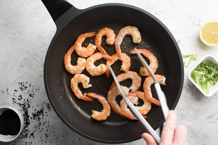 Shrimp cooking in a hot skillet.