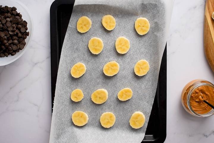 Slices of banana on parchment paper.