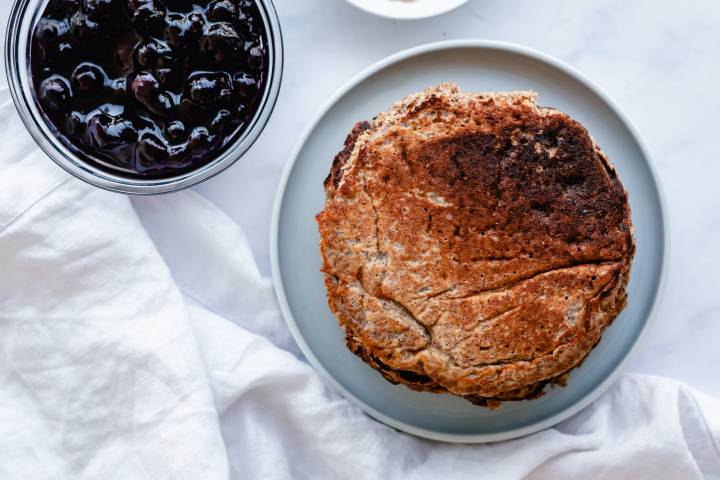 Flaxseed yogurt pancakes with blueberry sauce on the side.
