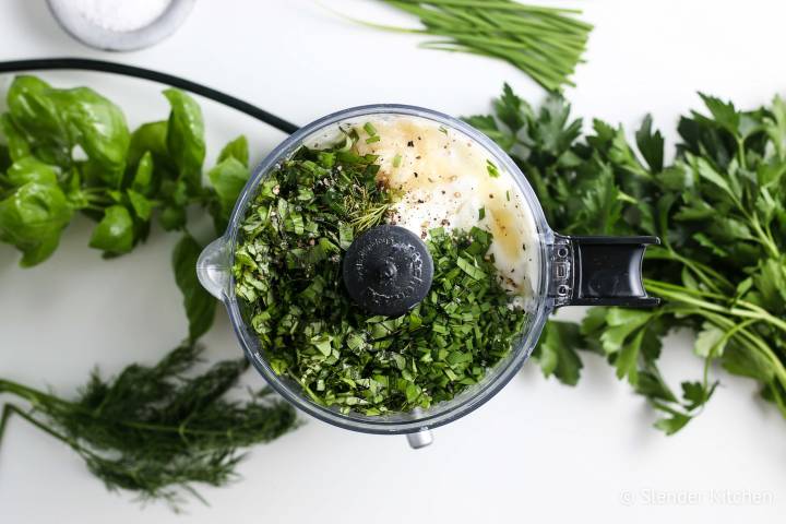 Chives, fresh herbs, yogurt, garlic, and  lemon in a food processor.