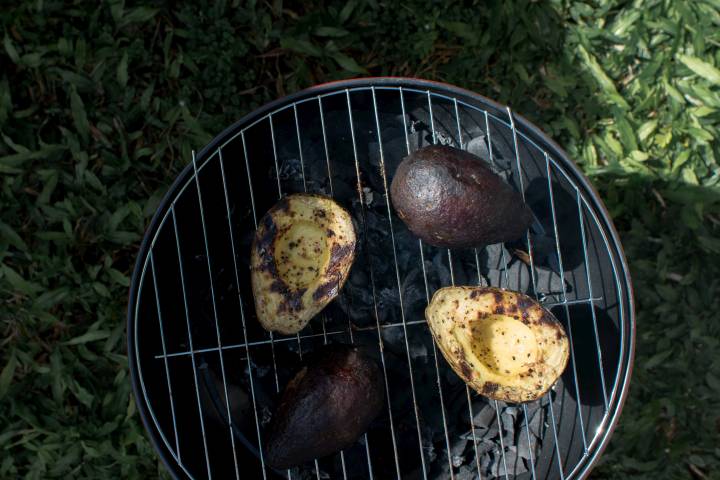 Avocados on the grill with grill marks. 