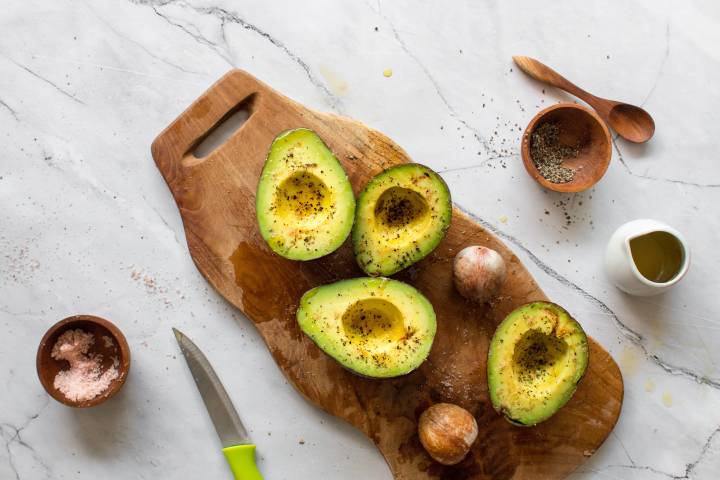 Avocados cut in half with olive oil, salt, and pepper.