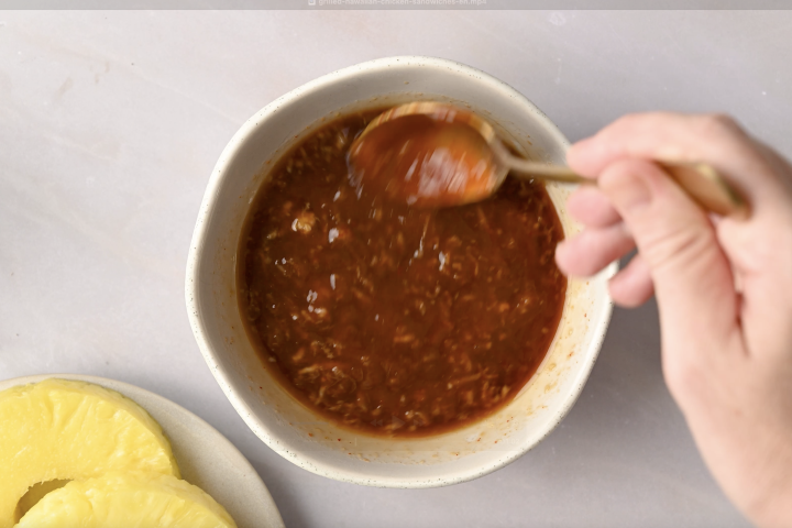 Hawaiian barbecue sauce in a small bowl being stirred.