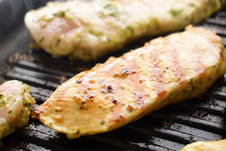 Cilantro lime marinated chicken being cooked on a grill pan.