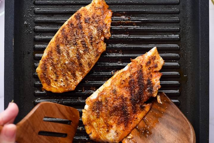 Mahi mahi cooking on a grill pan.