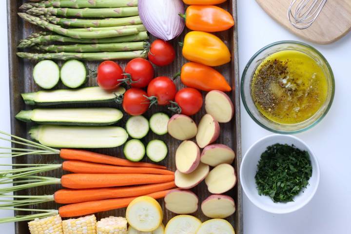 Chopped fresh vegetables in a cutting board before being grilled.