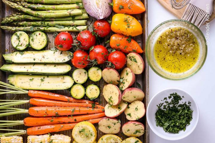 Vegetables brushed with marinade on a cutting board before being grilled.