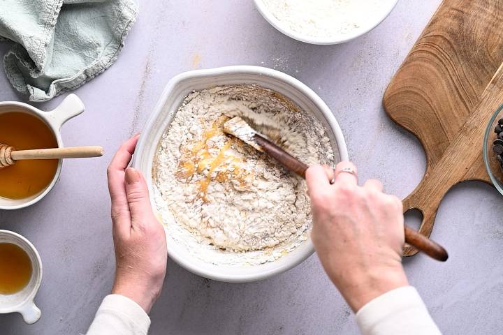 Flour being mixed into pumpkin and eggs.