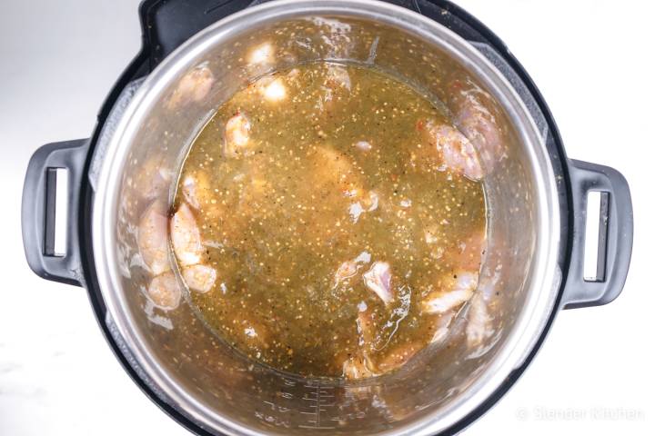 Chicken covered in salsa in an Instant Pot.