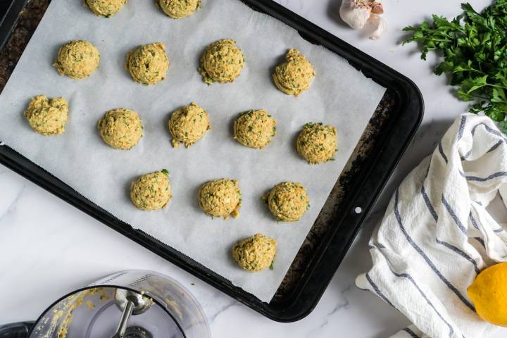 Baking sheet with unbaked lentil falafel.