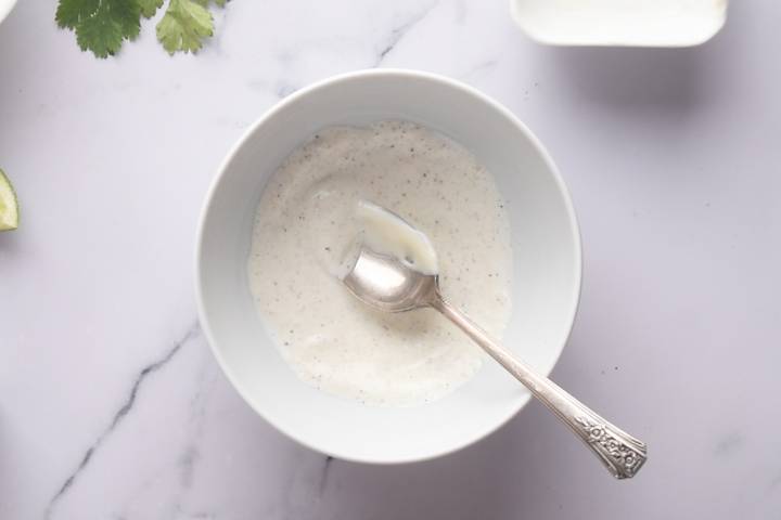 Mayonnaise, sour cream, salt, pepper, and garlic powder in a small bowl.