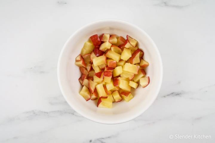Cooked apples in a bowl for oatmeal.