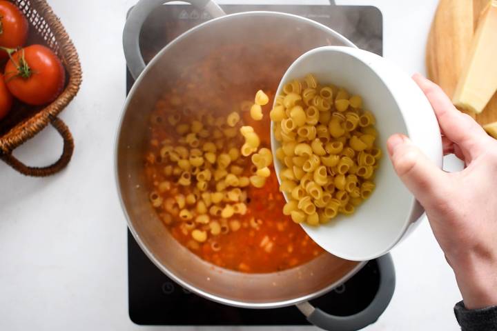 Pasta being added to pot for one pot pasta.