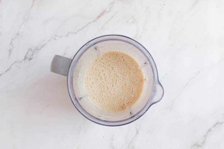 Blended orange creamsicle smoothie in a blender.