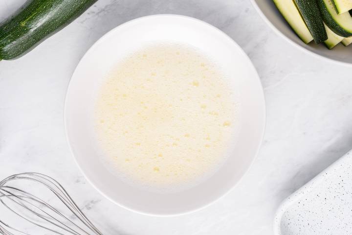 Whisked egg whites in a white bowl.