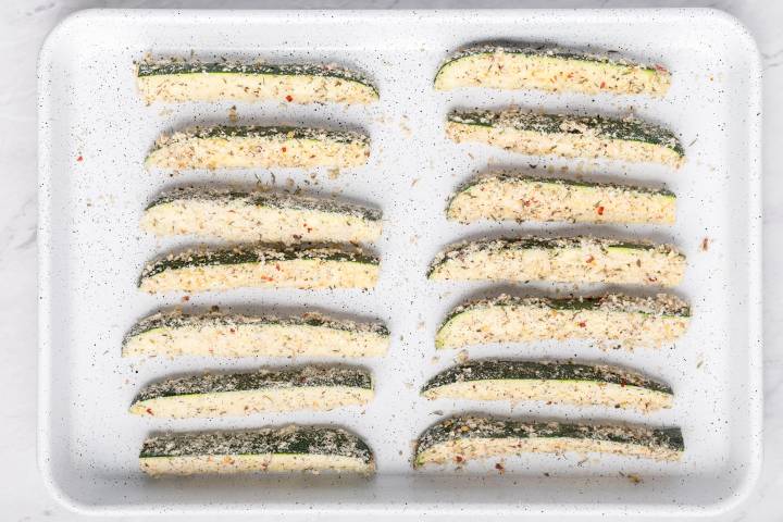 Zucchini fries on a baking sheet.