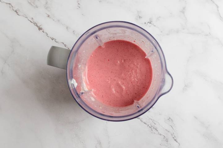 Strawvberry PB&J smoothie with Greek yogurt in a blender.