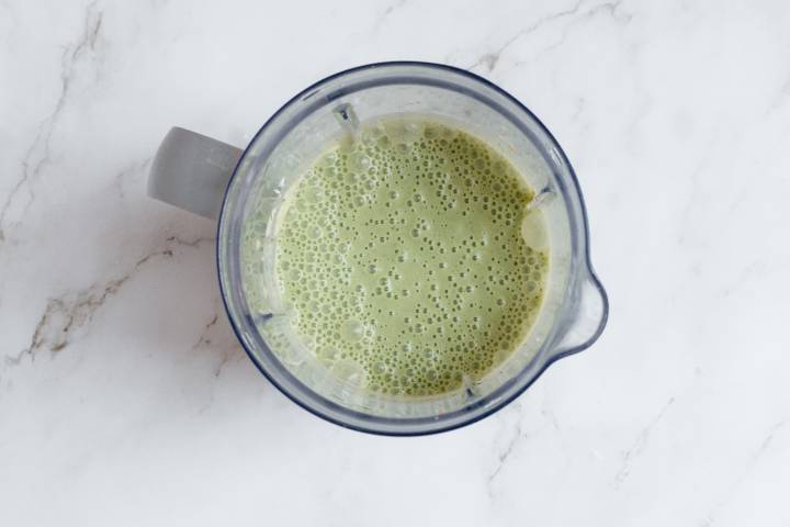 Peanut butter banana green smoothie in a blender.