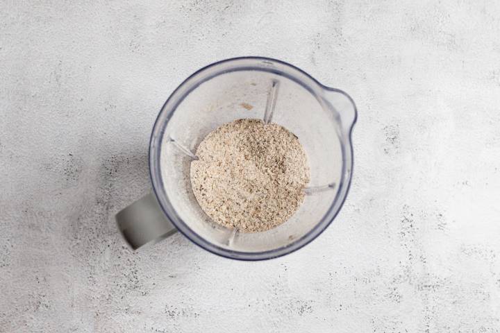 Rolled oats and chia seeds blended into a fine powder in a blender.