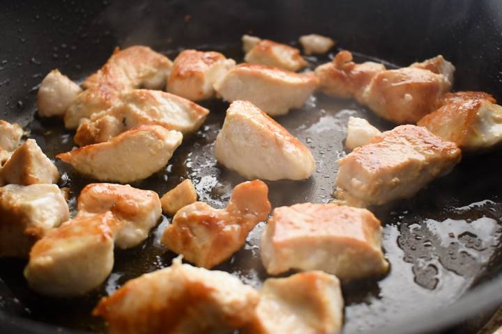 Chicken breast cooked in a pan with sesame and coconut oil.