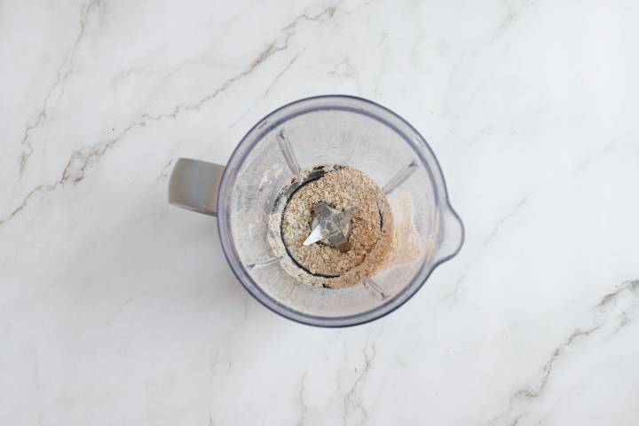 Rolled oats blended into flour in a blender.