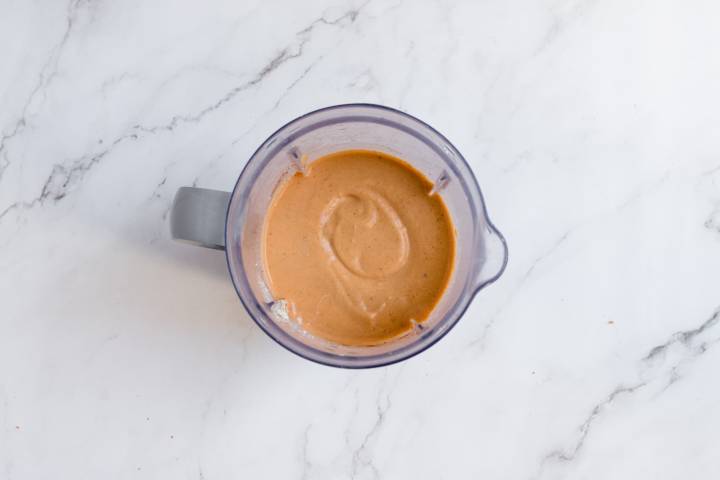 Creamy pumpkin pie smoothie in a blender.