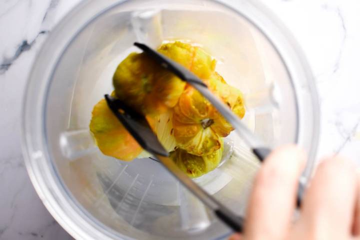 Tomatillos being blended for salsa verde.