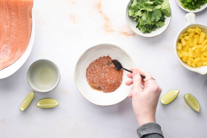 Blackening seasoning and olive oil being stirred in a small bowl.