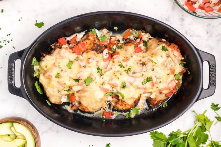 Baked salsa chicken with melted cheese and pico de gallo.