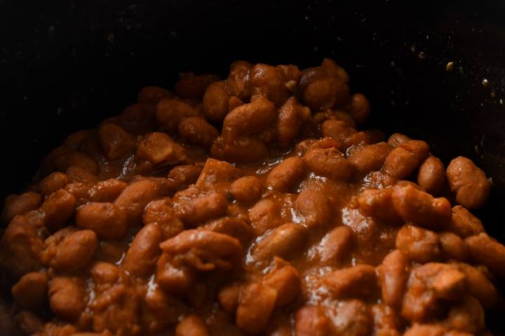 Creamy cooked borracho pinto beans in a slow cooker.