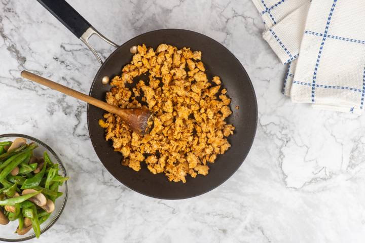 Ground turkey, garlic, ginger, and Chinese 5 spice cooking in a skillet.