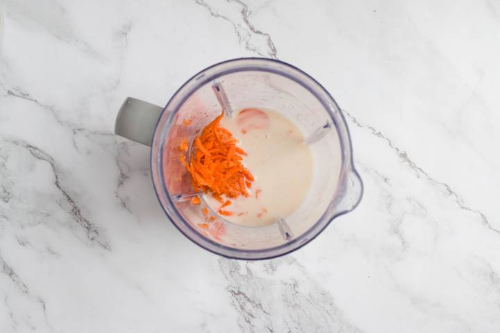 Shredded carrots and almond milk in a blender.
