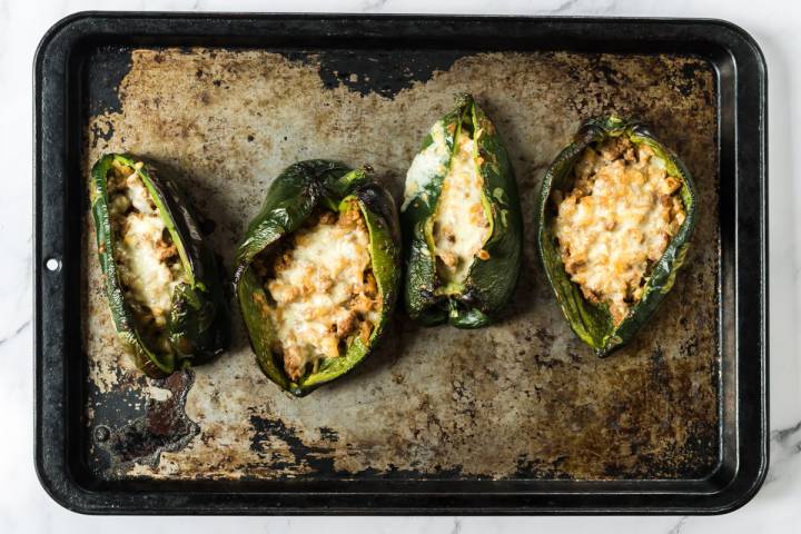 Stuffed poblano peppers with melted mozzarellaa cheese.