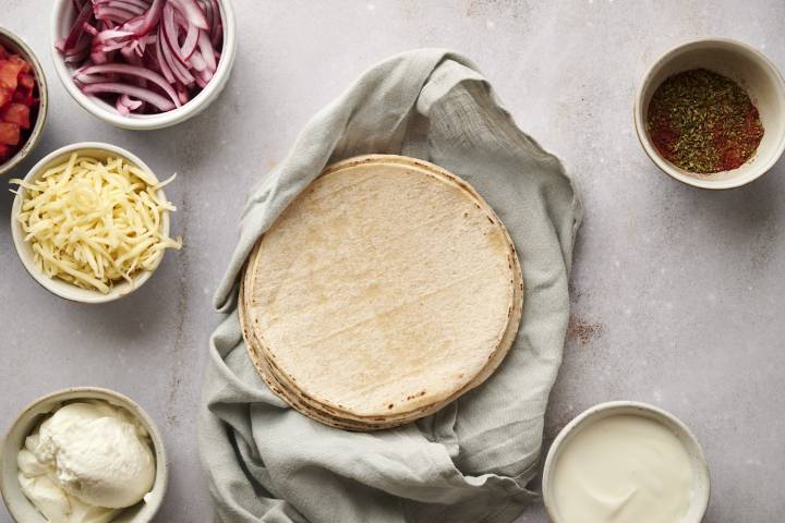 Corn tortillas wrapped in a blue napkin.