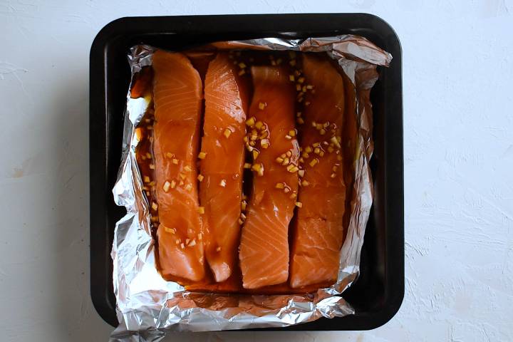 Salmon with teriyaki marinade in a dish with foil.