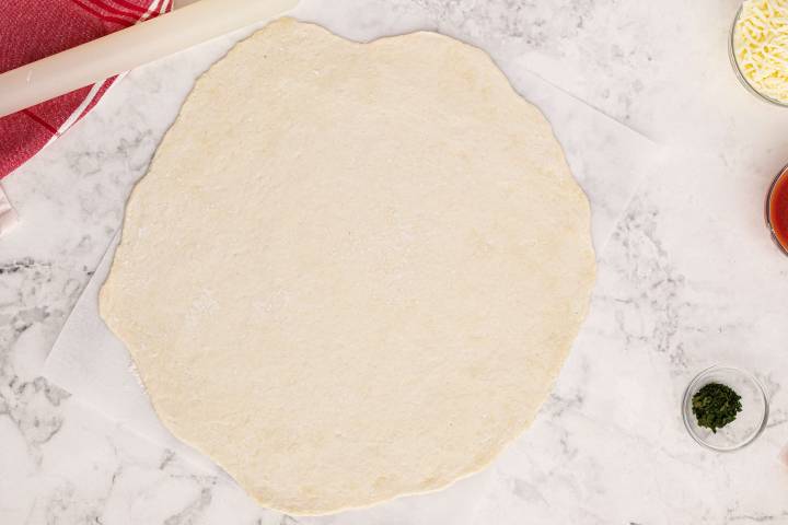 Two ingredient pizza dough after being rolled out.