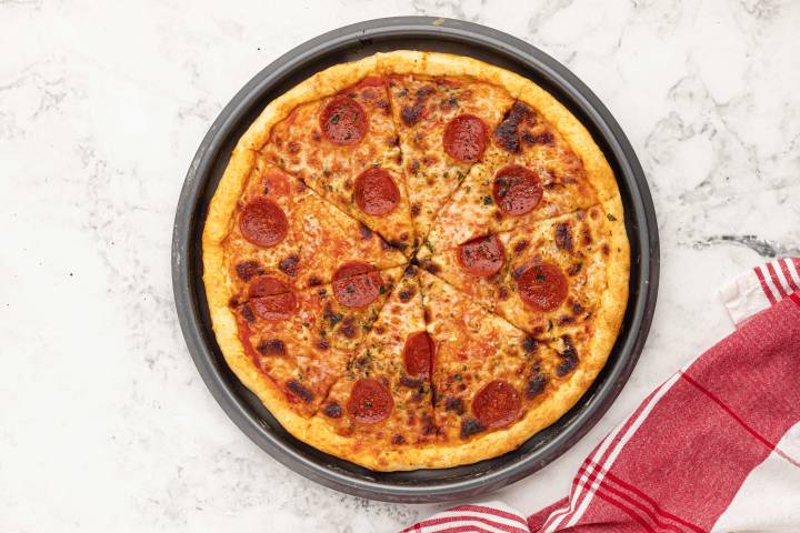 Two ingredient pizza cooked with pepperoni and cheese.