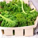Kale in a wooden basket with a gray napkin.
